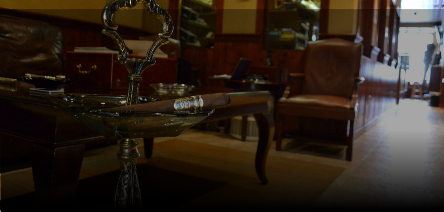 A cigar resting on a brass ashtray inside the Mane Street lounge
